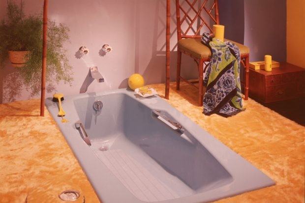 A view of a bathroom interior showing a sunken blue tub and wall to wall yellow shag carpeting. (Photo by Getty Images)