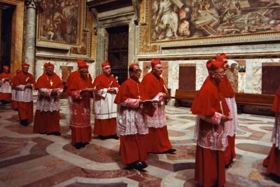 A procession of cardinals file into the Vatican